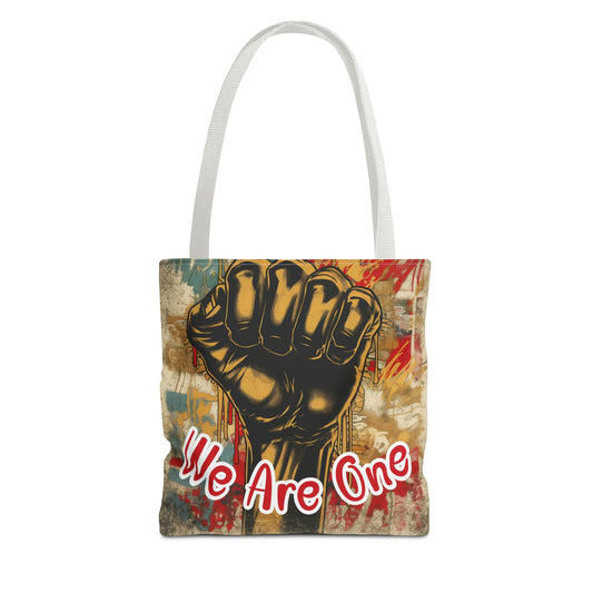 Empowering 'We Are One' tote bag featuring a bold raised fist design, symbolizing unity and strength, perfect for everyday use. 