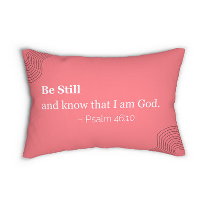 A faith-based lumbar pillow featuring the verse "Be Still and know that I am God" – Psalm 46:10. Double-sided print with a water-resistant pink polyester cover and concealed zipper.