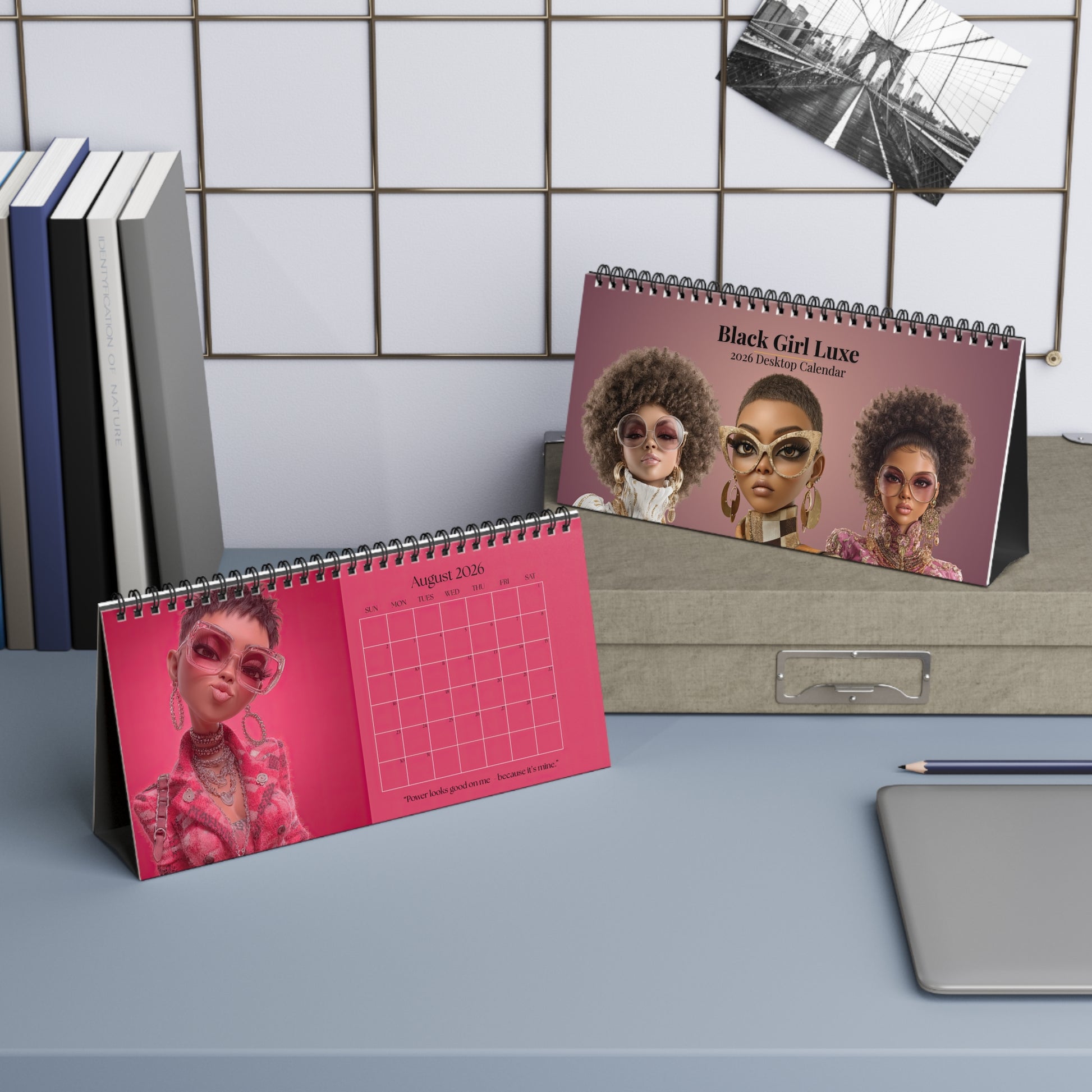 Black Girl Luxe 2026 desktop calendar cover and the month of August featuring a stylish Black women with natural hair, oversized glasses, and luxury fashion on mauve and pink backgrounds.