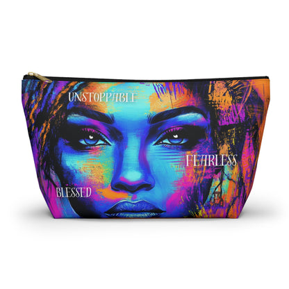 A vibrant accessory pouch featuring a bold portrait of a woman with empowering words like "Unstoppable," "Fearless," and "Blessed" in striking colors. Available in two sizes.